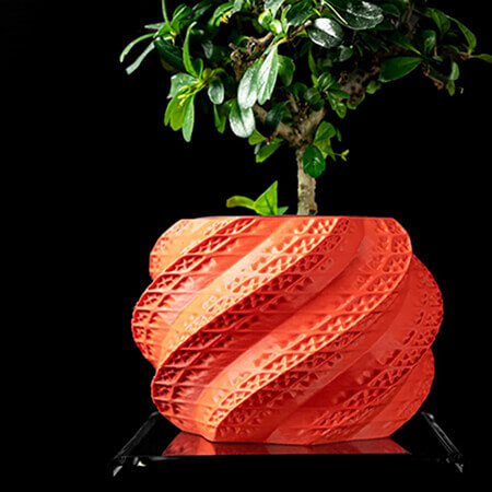 Red twisted leaf 3D printed PLA planter with spiral geometric design and bonsai plant, modern artistic texture, by Plantale.