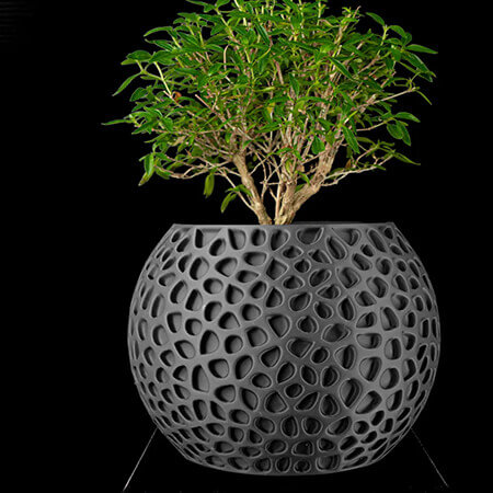 Modern black textured 3D printed PLA planter with geometric hollow pattern, featuring green bonsai plant, contemporary design by Plantale.
