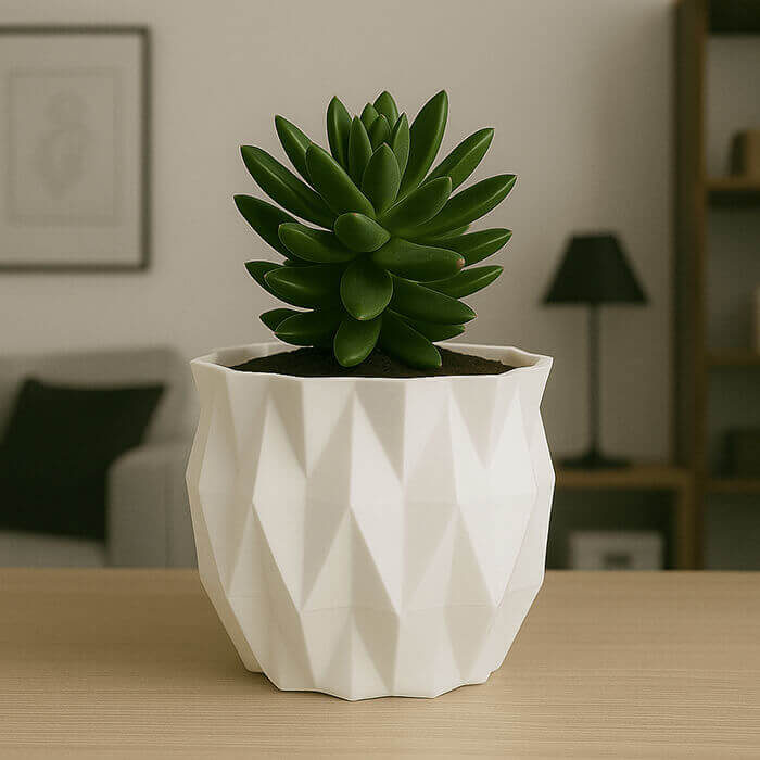 Modern white faceted 3D printed PLA planter with green succulent on a wooden table indoors.