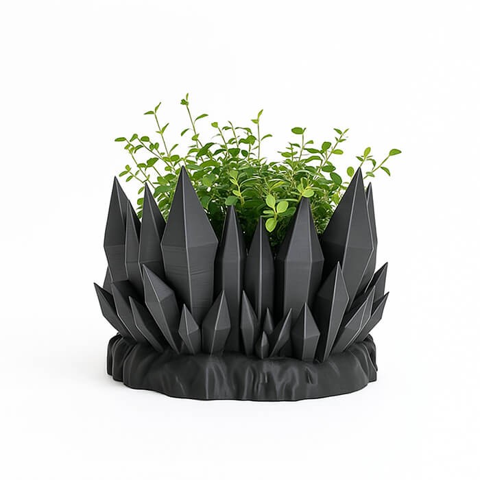 Black crystal mountain 3D printed PLA planter with sharp geometric crystal spikes, holding green indoor plant, modern sculptural design by Plantale.