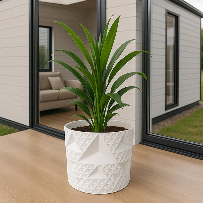 White endless triangle 3D printed PLA planter with geometric pyramid pattern, holding tall green indoor plant, modern home decor by Plantale.