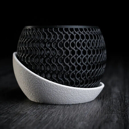 Black wavy mesh 3D printed PLA planter with white curved tray, modern textured lattice pattern, minimalist tabletop design by Plantale.