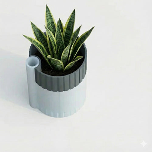 Top-view of a two-tone self-watering planter featuring a dark inner container with a small drainage hole and a light outer reservoir that includes a narrow cylindrical water-fill tube on the side.