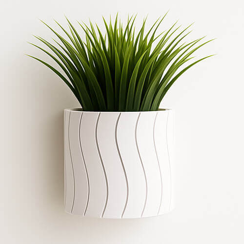 White 3D-printed wall-mount planter with modern wave texture and green plant