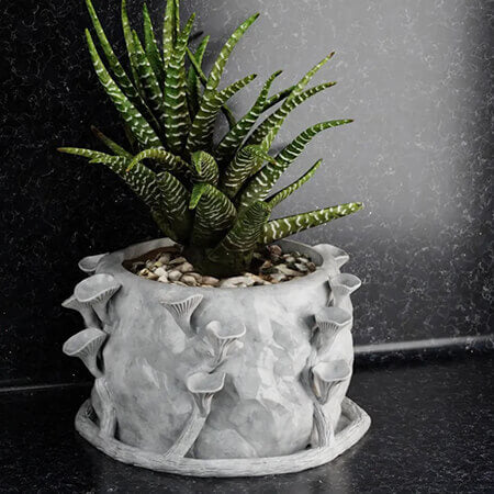 White forest mushroom 3D printed PLA planter featuring a green succulent plant, detailed organic mushroom design, handcrafted look by Plantale.