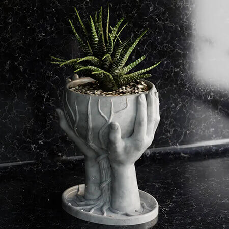 White hands holding tree 3D printed PLA planter featuring a green succulent plant, sculptural nature-inspired design on black marble surface, by Plantale.